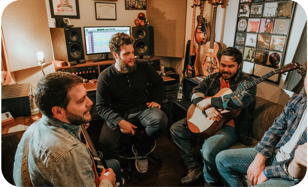Band members meeting with Travis Geiman in the studio